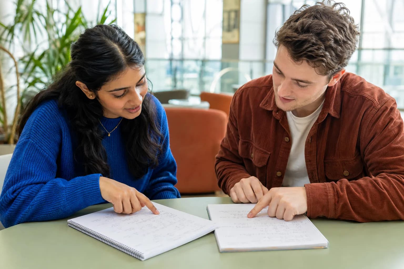 Two adult learners comparing a product rule solution with an expanded polynomial solution